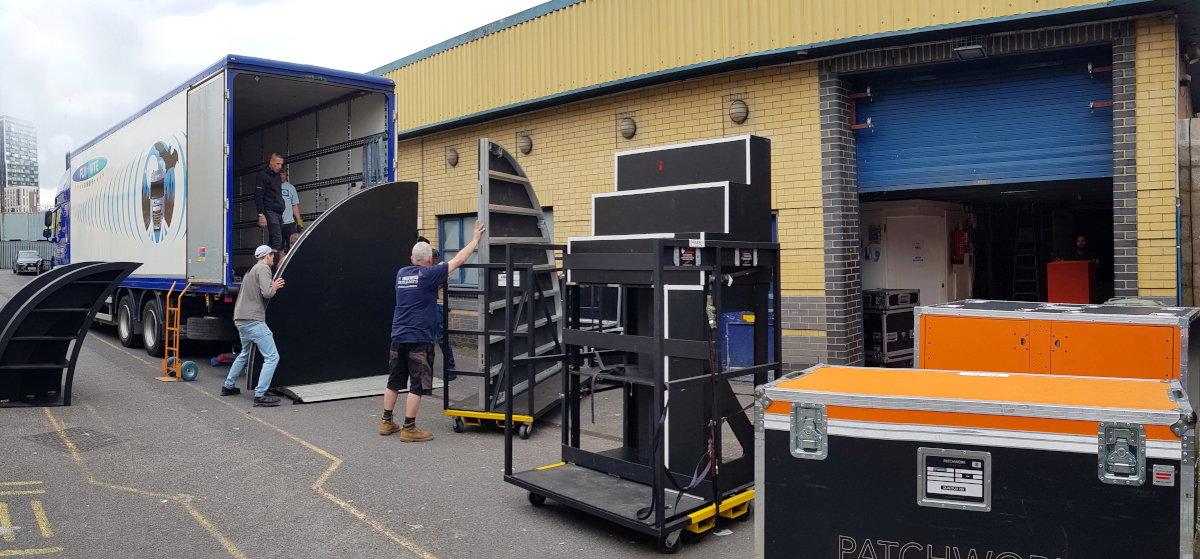 Men unloading scenery from the back of a lorry at Soundstage Studios in North West London